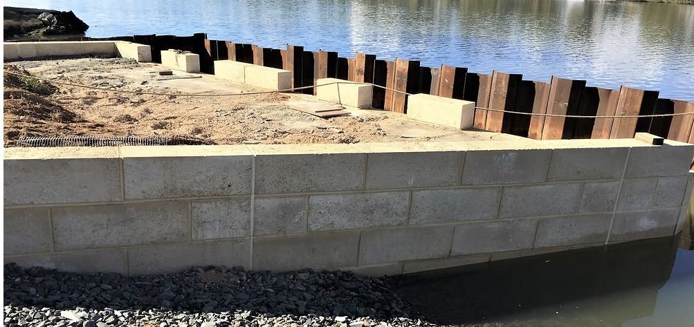 Limestone block seawall along a waterfront during construction